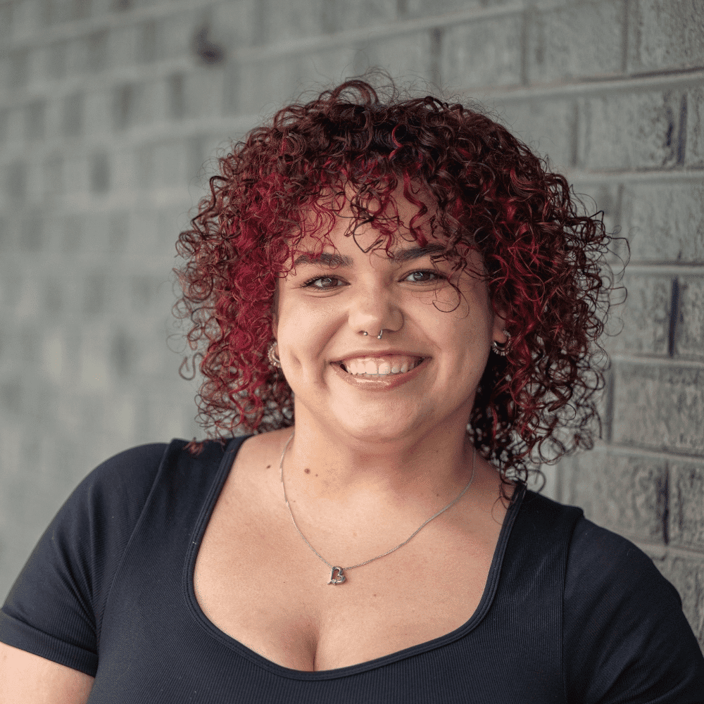 Portrait of Sage, a professional stylist at Salon Ciseaux, showcasing their expertise and style.