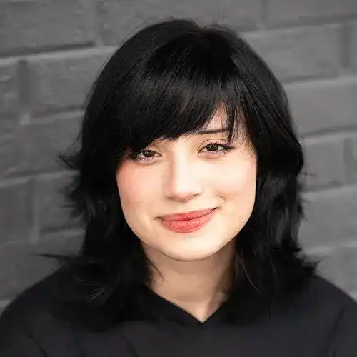 Portrait of Yoshira, a professional stylist at Salon Ciseaux, showcasing their expertise and style.