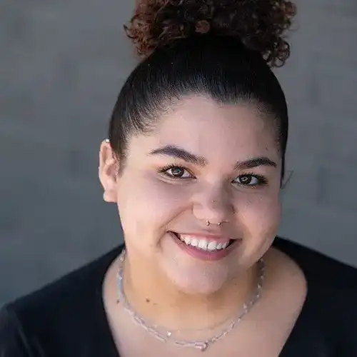 Portrait of Sage, a professional stylist at Salon Ciseaux, showcasing their expertise and style.