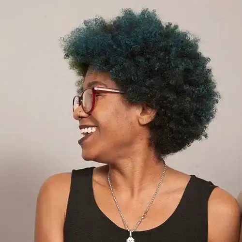 Portrait of Sterling, a professional stylist at Salon Ciseaux, showcasing their expertise and style.