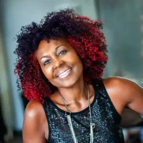 Portrait of Arlene Webber, a professional stylist at Salon Ciseaux, showcasing their expertise and style.